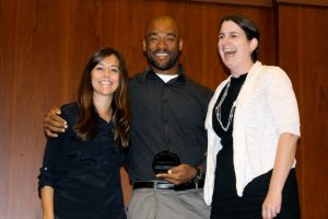 Omega Psi Phi member, center, accepts NC State's 2013 Most Sustainable Chapter Award from Lauren McKinnis, outreach coordinator for Waste Reduction and Recycling, and Tracy Dixon, director of the University Sustainability Office.