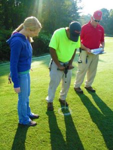 Students and staff perform initial soil testing before compost is applied to University Recreation's fields on Centennial Campus.