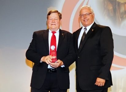 Jack Colby, left, receives the APPA Distinguished Leadership and Ethics Award on July 13 in Nashville, Tenn.