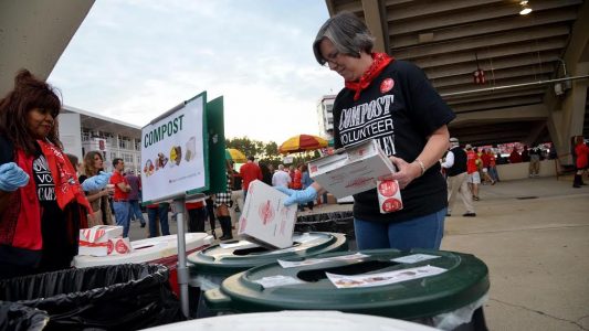 Carter-Finley Composts volunteers assist fans in sorting waste into composting, recycling or landfill bins.