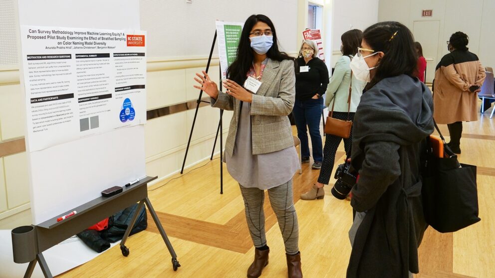 woman discussing a research poster