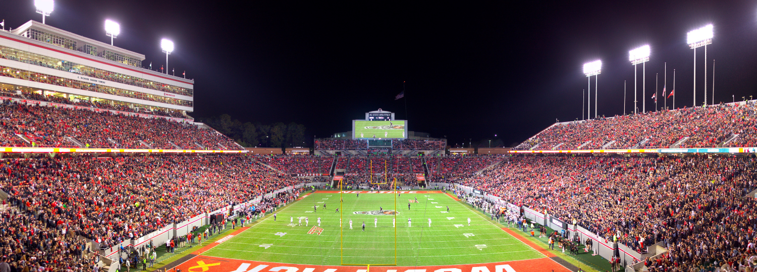 Carter Finley Stadium filled with spectators at night.