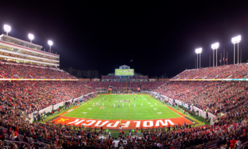 Carter Finley Stadium filled with spectators at night.