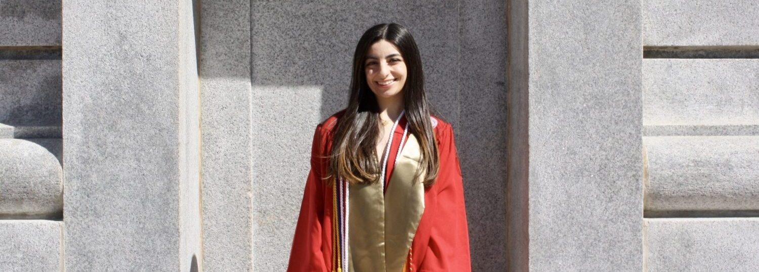 Loujain Al Samara poses in graduation robes.