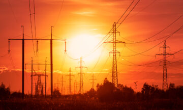 Power lines on a background of sunset in disturbing red tones
