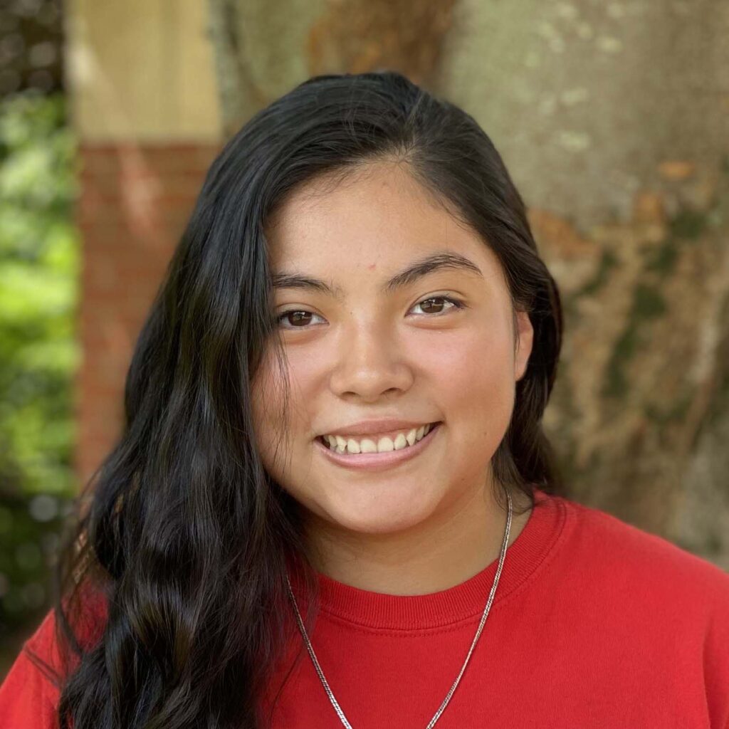 Headshot of Nicole Rosales-Garica in a red shirt and necklace.