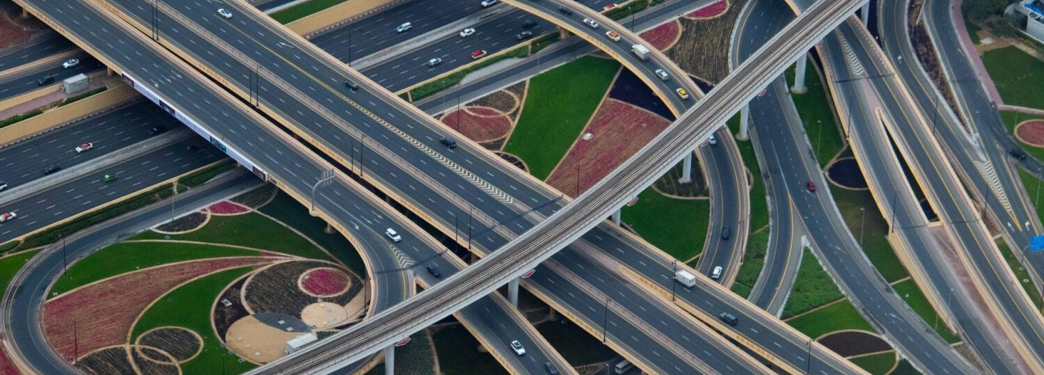 aerial view of a complex highway interchange featuring more than a dozen lanes of traffic going in half a dozen directions