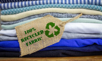 Recycle clothes icon on fabric label with 100% Recycled text, concept illustration reuse, recycle clothes and textiles to reduce waste.