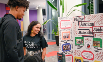 Students look at a Native American Student Association display.