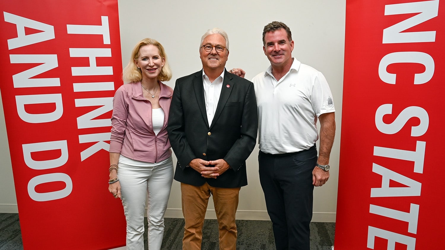 Chancellor Woodson of NC State poses with the Under Armour founder and the Under Armour CEO.