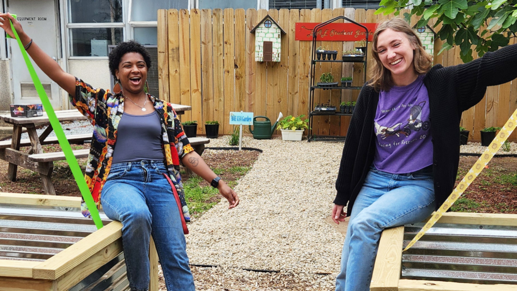 Jasmine Gibson left and Megan Carr right celebrate the opening of the BAE PEER Garden