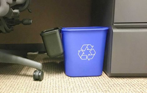 Mini landfill bins clip onto a full-size, deskside recycling bin. At University of North Carolina at Charlotte, use of mini-bins have increased recycling by 15 percent and save $13,000 annually by not needing to purchase plastic liners for waste bins.