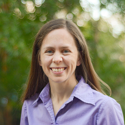 Headshot of Carla Davis in a purple dress shirt.