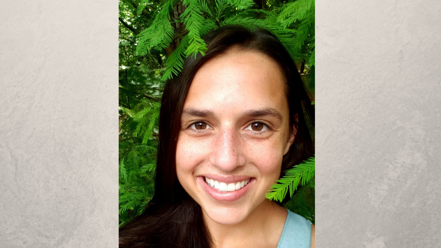 Headshot of student in front of ferns.