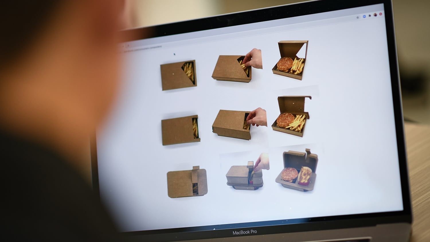 A computer screen shows different take-out containers with food inside.