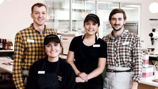 Katie Godfrey Kilgore and employees pose in Fount Coffee and Kitchen. Processed with VSCO with j2 preset