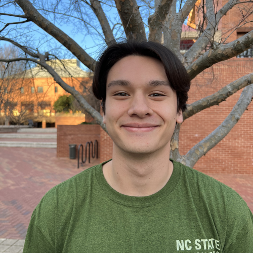 Headshot of Harrison Liam King in green NC Sate Stewards shirt.