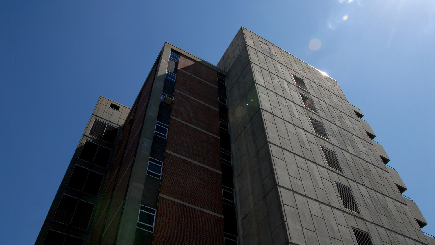 Dabney Hall on campus looking up towards blue sky.