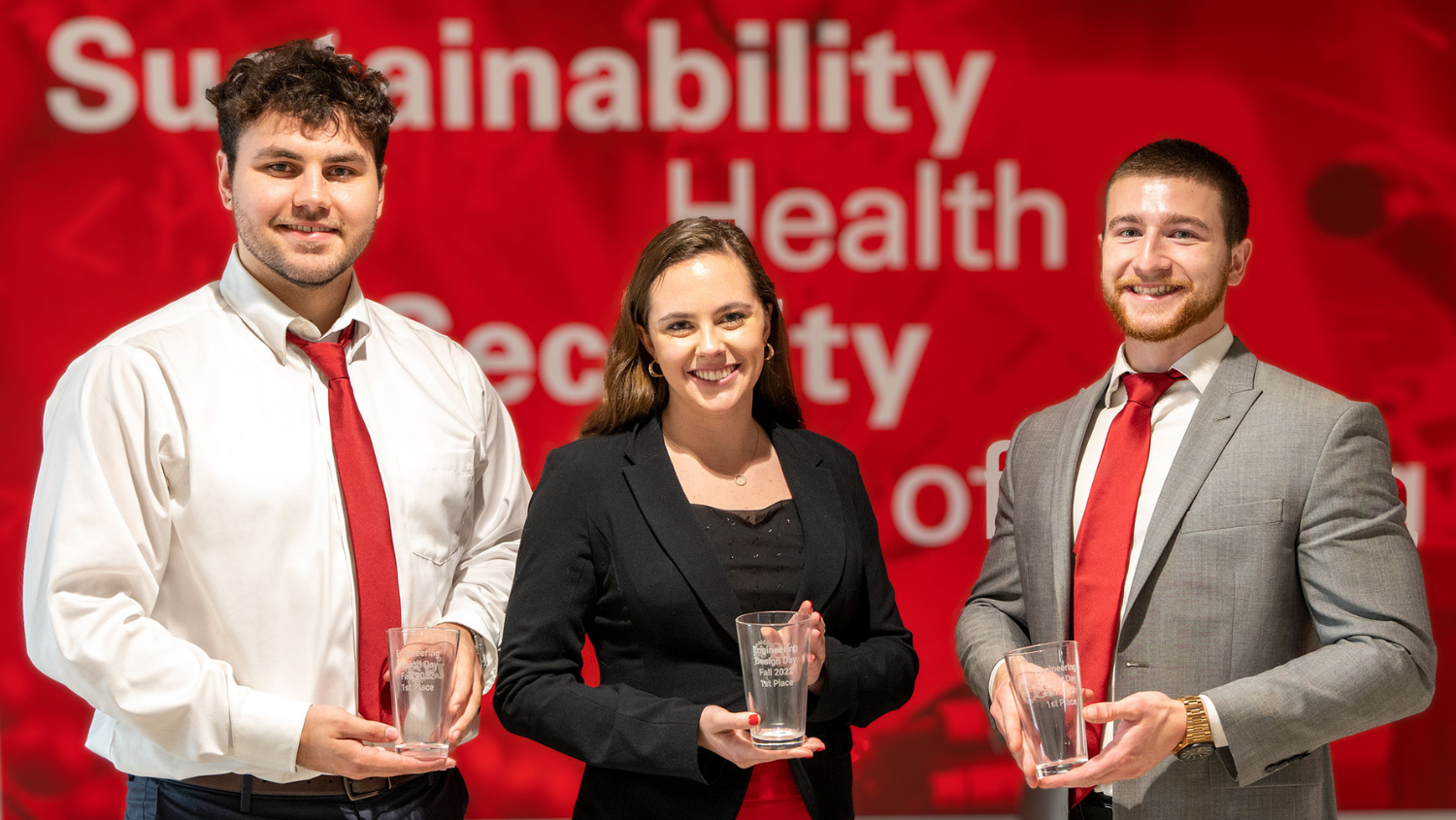 Nick Berinson, Colin Lawler and Mallory Padgett hold their 1st place trophy for ISE 2022 Design Day