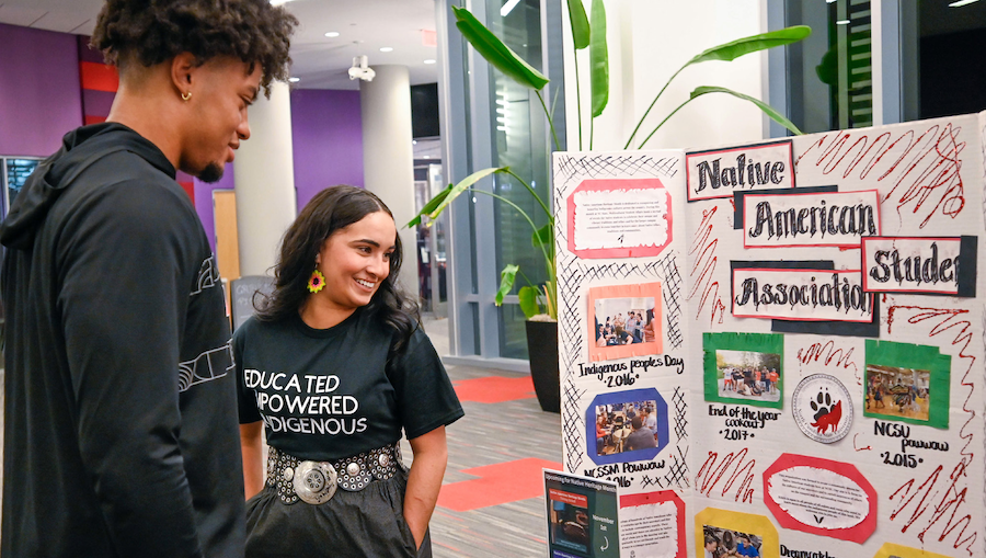 Students look at a Native American Student Association display.