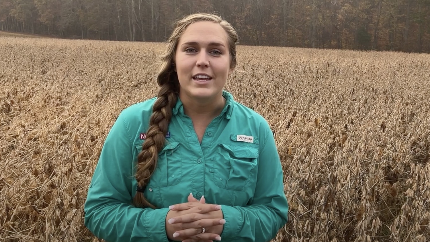 Woman standing at a farm field.