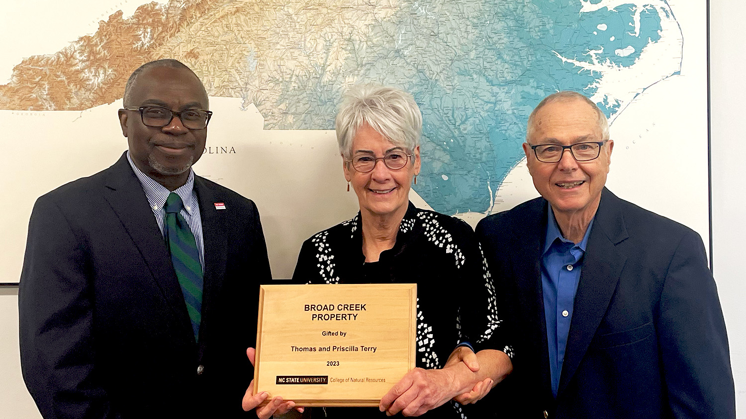 Tom and Priscilla Terry standing with Dean Myron Floyd.