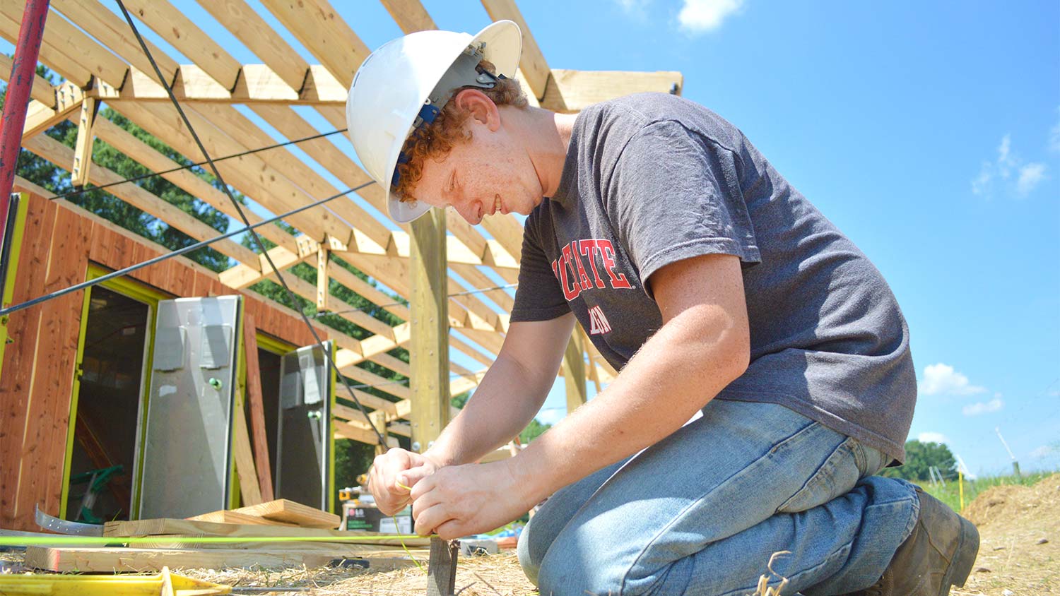 Architecture student Jacob Fremderman works at the Agroecology Education Farm, where he and 14 other students are constructing a building they designed. The new facility will help advance the productivity of the farm, which grows sustainable farm-to-fork produce for university dining halls.